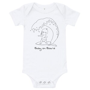 May include: White babygrow with a black line drawing of a baby wearing sunglasses and surfing on a wave. The text "Baby on Board" is written below the image.