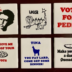 May include: Six white square ceramic tiles with black and red text and illustrations. The tiles feature phrases and images from the movie "Napoleon Dynamite", including "Napoleon Dynamite", "Liger", and "Vote for Pedro".