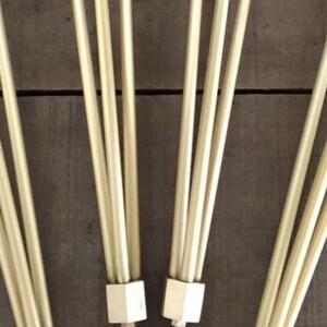 May include: Four sets of gold metal legs with a hexagonal base and a round foot. The legs are arranged in a fan shape.