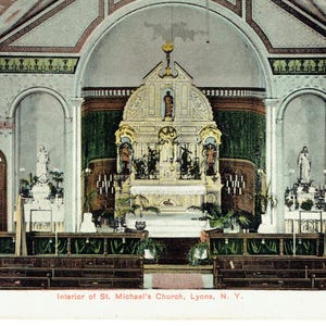 May include: A vintage postcard showing the interior of St. Michael's Church in Lyons, N.Y. The image depicts a detailed altar, wooden pews, and arched ceilings. The colour scheme includes muted greens, browns, and creams, evoking a sense of historical reverence.