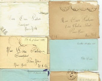 May include: A collection of vintage envelopes in various colors, including cream, blue, and tan. Each envelope features handwritten addresses and postmarks, with the name "Doris Pulver" visible on several. The envelopes are from New York and Penn Yan.