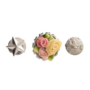 May include: Three decorative pins arranged horizontally. The left pin is a silver-toned five-pointed star. The center pin is a circular bottle cap base adorned with fabric roses in shades of pink and yellow with green leaves. The right pin is a silver-toned circular disc featuring a textured, embossed map of the world.