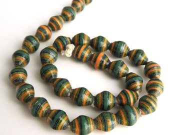 May include: A strand of green, orange, and blue paper beads. The beads are made of rolled paper and have a striped pattern.