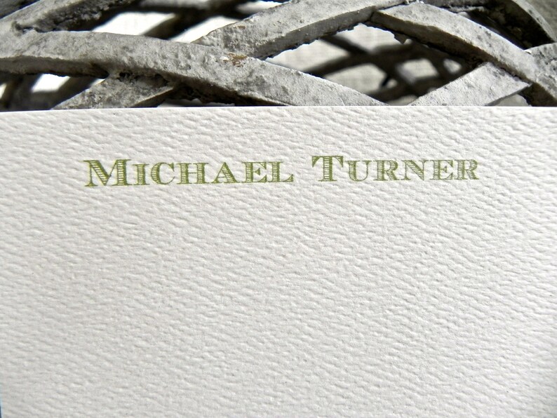 May include: A white card with the name "MICHAEL TURNER" printed in green letters.