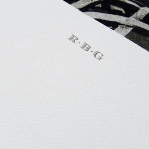 May include: White stationery with the initials "R.B.G." printed in gray.