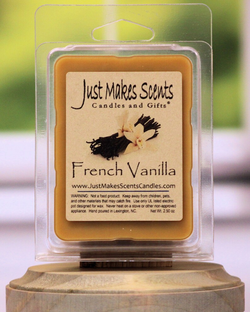 May include: A clear plastic container with a brown wax melt inside. The wax melt is labeled "Just Makes Scents Candles and Gifts" and "French Vanilla". The label also includes the website address "www.JustMakesScentsCandles.com" and a warning about using the wax melt safely. The wax melt weighs 2.50 ounces.