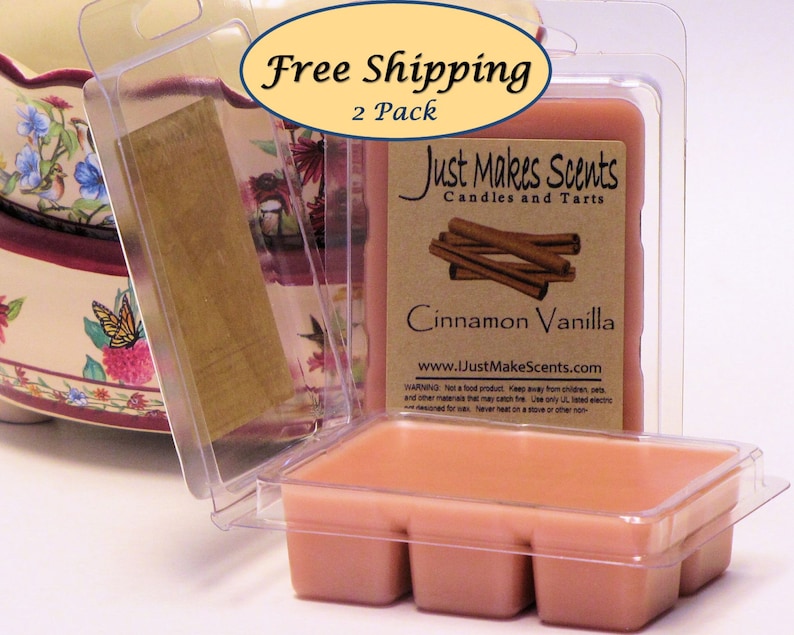 May include: Two-pack of cinnamon vanilla scented wax melts in clear plastic containers. The wax melts are a light peach color. The label reads "Just Makes Scents Candles and Tarts" and "Cinnamon Vanilla".