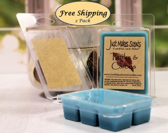 May include: Two clear plastic containers with lids, each containing a teal wax melt. The wax melt is labeled "Just Makes Scents Candles and Gifts" and "Turks & Caicos".
