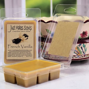 May include: A clear plastic package containing a wax melt with a brown label that reads "Just Makes Scents Candles and Gifts" and "French Vanilla". The label also includes the website address "www.JustMakesScentsCandles.com".