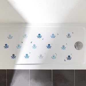 May include: A white shower floor with blue and white octopus decals. The decals are scattered across the floor in a random pattern.