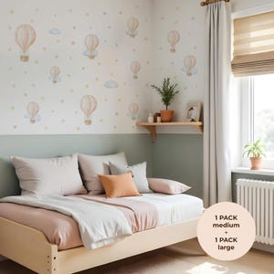 May include: A bedroom with a light wood bed, pillows, and a pink and white duvet cover. The wall is decorated with hot air balloon decals in pastel shades. The image text reads "1 PACK medium + 1 PACK large."