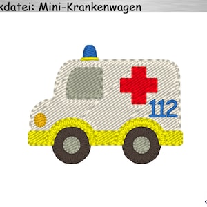 Puede incluir: Una ambulancia de juguete blanca con una cruz roja y el número 112 en el lateral. La ambulancia tiene ribetes amarillos y luces azules en la parte superior.