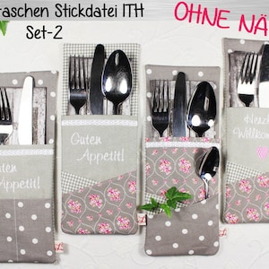 May include: Four grey fabric cutlery holders with different patterns and embroidered sayings. The holders are for forks, knives, and spoons. The text on the holders reads "Guten Appetit!" and "Herzlich Willkommen!"
