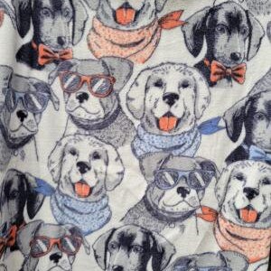 May include: A white fabric with a repeating pattern of dogs wearing sunglasses, bowties, and scarves. The dogs are in various poses and have different colored fur.
