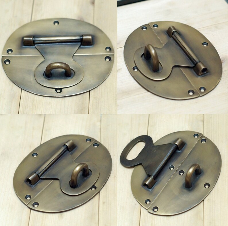 May include: Four antique brass oval-shaped box clasps with a hinged design. Each clasp has a different style of latch and a decorative ring.