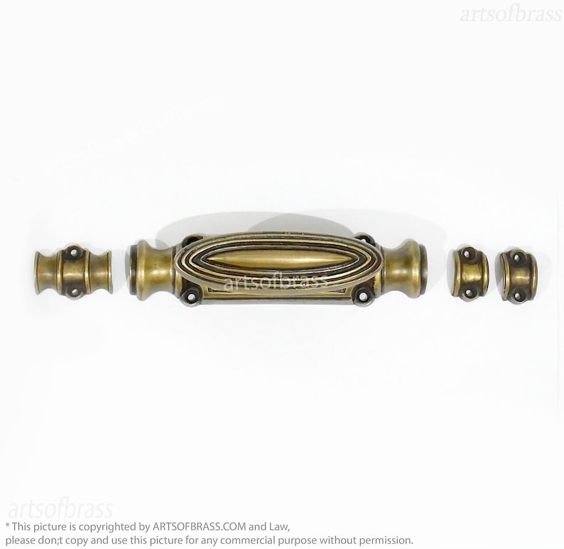 May include: A brass door latch with an oval-shaped handle and two round knobs. The latch is in a polished brass finish.