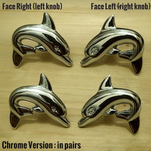 May include: Four chrome dolphin door knobs, two facing left and two facing right. The knobs are in pairs, with the text "Face Right (left knob)" and "Face Left (right knob)" above each pair. The text "Chrome Version: in pairs" is below the knobs.