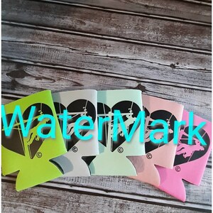 May include: Five different colored can coolers with a black silhouette of a horse jumping over a fence in a heart shape. The can coolers are green, light blue, dark blue, pink, and white.