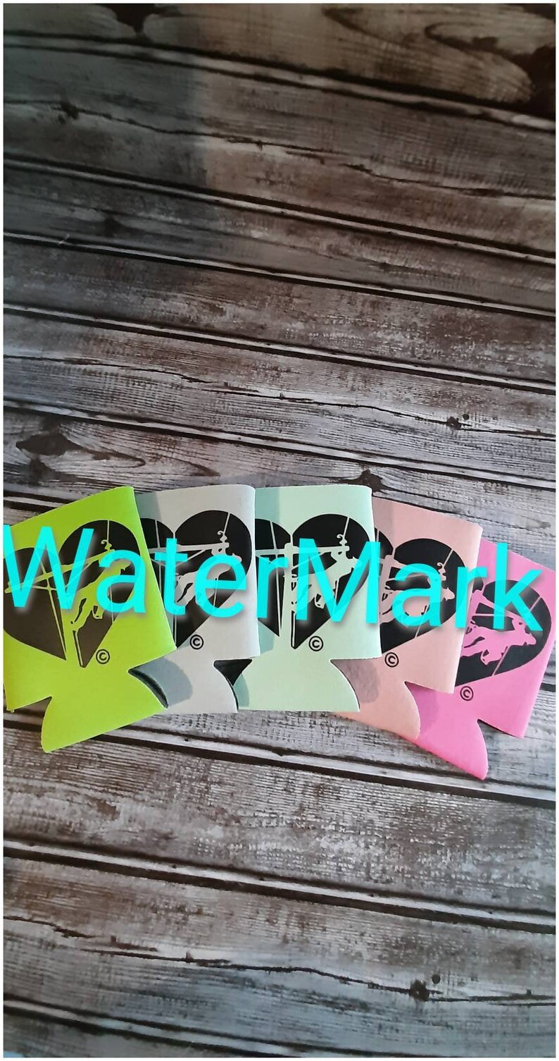 May include: Five different colored can coolers with a black silhouette of a horse jumping over a fence in a heart shape. The can coolers are green, light blue, dark blue, pink, and white.