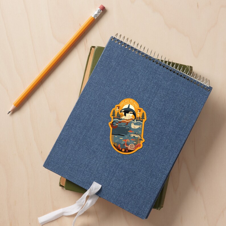 May include: A yellow and blue sticker with an illustration of a whale and other sea creatures. The sticker says "Orcas Island Washington State".