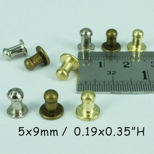 May include: Assortment of small metal knobs in silver, gold, and bronze finishes. The knobs are approximately 5mm in diameter and 9mm tall. 5x9mm / 0.19x0.35" H