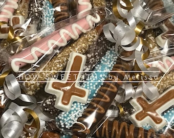 May include: A close-up of a variety of chocolate-covered pretzels, some with sprinkles, some with chocolate drizzle, and some with a chocolate cross. The pretzels are packaged in clear plastic bags and tied with gold and silver ribbon. The text "HOW SWEET IT IS by Melissa" is visible in the image.