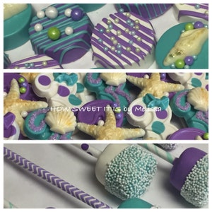 May include: Purple and teal chocolate covered Oreos decorated with white chocolate, sprinkles, and seashells.  The text "HOW SWEET IT IS by Melissa" is visible in the image.