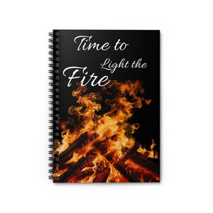 May include: Spiral-bound notebook with a black cover featuring the text "Time to Light the Fire" in white script. The cover design includes a vibrant image of a bonfire with orange and yellow flames against a black background.