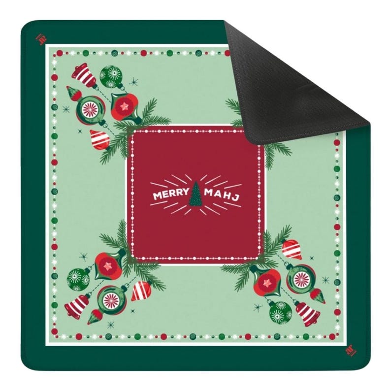 May include: A square mat with a dark green border and a light green centre featuring a red rectangular panel. The text MERRY MAHJ is printed in white with a small tree icon. The design includes red and green ornaments and pine branches.