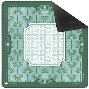 May include: A rectangular game mat in shades of green and teal, featuring a palm tree design and a white geometric pattern. The mat includes the text "THE CHARLESTON" and game instructions. The reverse side of the mat is black.