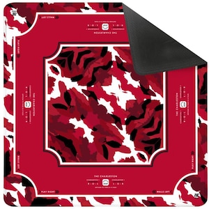 May include: A square Mahjong mat featuring a red, white, and black camouflage-style pattern in the center. The border is solid red with white text reading THE CHARLESTON, instructions for passing tiles, and directional arrows for play.