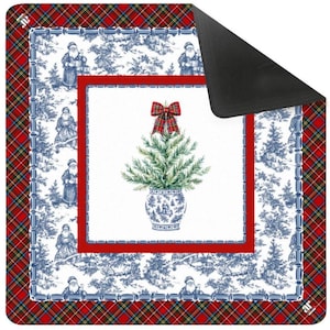 May include: A Christmas-themed mat featuring a central image of a decorated evergreen tree in a blue and white vase, topped with a red plaid bow. The mat has a red plaid border and a blue and white toile pattern with Santa Claus figures.