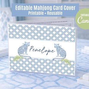 May include: A clear plastic Mahjong card cover with a blue and white lattice pattern. The cover features the name "Penelope" and two blue leopard illustrations. Text at the top reads "Editable Mahjong Card Cover Printable Reusable".