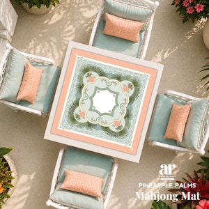 May include: Overhead view of a white square table with a decorative mat and four white chairs with cushions. The mat has a floral design with a light green and peach color scheme. Peach-colored rectangular pillows are on the chairs. The text "PINEAPPLE PALMS Mahjong Mat" is visible.