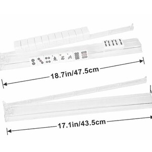 May include: Clear plastic Mahjong tile racks with measurements of 18.7 inches/47.5cm and 17.1 inches/43.5cm. The racks are shown with tiles and have text on them. The height is 2.12 inches/5.4cm.
