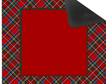 May include: Square red mat with a tartan plaid border in red, green, blue, and yellow. The mat has a solid red center and a black underside. The corners of the plaid border have the letters "ar".