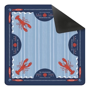 May include: A square, navy blue mat with a light blue striped background and four red lobster illustrations. The mat has the text "THE CHARLESTON" and "PLAY RIGHT" and "WALLS LEFT" in white. The mat is designed for a game.