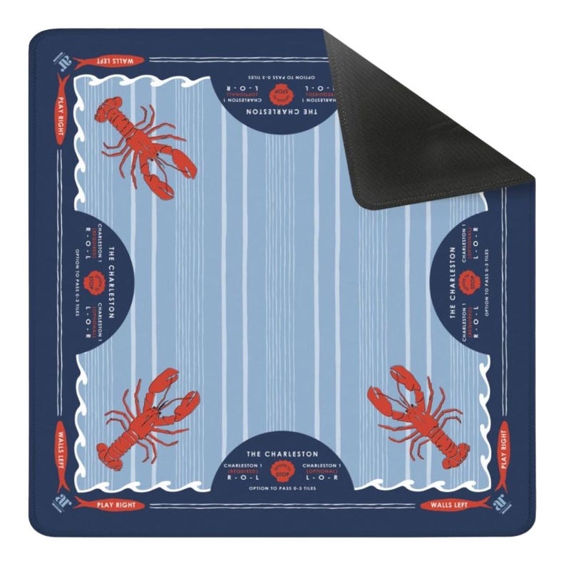 May include: A square, navy blue mat with a light blue striped background and four red lobster illustrations. The mat has the text "THE CHARLESTON" and "PLAY RIGHT" and "WALLS LEFT" in white. The mat is designed for a game.