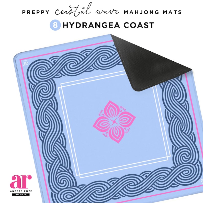 May include: A light blue Mahjong mat with a coastal wave design. The mat features a pink and white floral design in the center and a border of navy blue waves. The text "PREPPY coastal wave MAHJONG MATS 8 HYDRANGEA COAST" is visible.