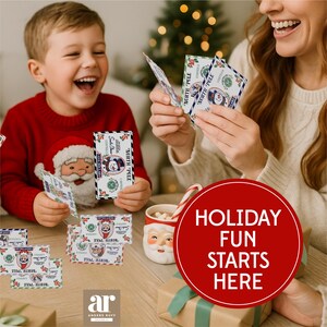 May include: A festive scene with a child and an adult holding holiday-themed cards. The cards feature a snowman and Santa Claus design. A mug with a Santa face and a candy cane are also visible. The image has the text "HOLIDAY FUN STARTS HERE".