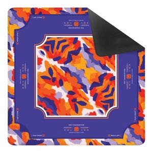 May include: A square, patterned mat with a blue border and a central design of orange, purple, and white brushstrokes. The mat has text that reads "The Charleston" and "Play Right" and "Walls Left".