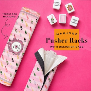 May include: Pink and white striped Mahjong pusher rack case with champagne bottle pattern. The case is open, revealing clear plastic pusher racks. The image also shows Mahjong tiles and the text "PRESS FOR MAHJONG".