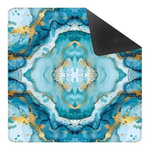 May include: A square mousepad with a teal and gold abstract design. The pattern features swirling teal and blue hues with gold accents, creating a marbled effect. The bottom right corner is black, and the top left corner has a small logo.