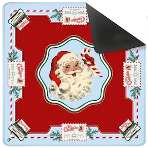 May include: A square Christmas-themed mat with a red and light blue design. The mat features a central image of Santa Claus holding a candy cane, surrounded by decorative elements like stamps, typewriters, and pine branches. The text "The Charleston" is visible.