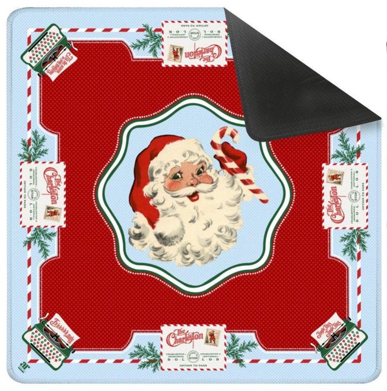 May include: A square Christmas-themed mat with a red and light blue design. The mat features a central image of Santa Claus holding a candy cane, surrounded by decorative elements like stamps, typewriters, and pine branches. The text "The Charleston" is visible.