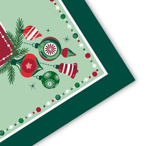 May include: A square napkin with a light green background featuring a festive illustration of red and green Christmas ornaments, pine branches, and a bell. The design is framed by a border of red and green beads and a dark green outer edge.