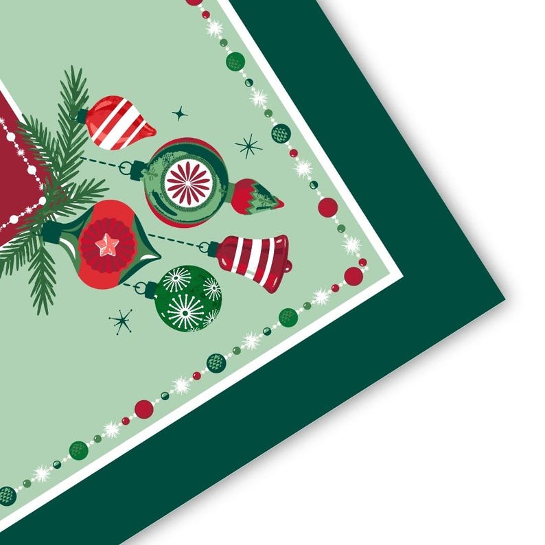 May include: A square napkin with a light green background featuring a festive illustration of red and green Christmas ornaments, pine branches, and a bell. The design is framed by a border of red and green beads and a dark green outer edge.