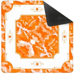 May include: A square, orange and white mat with a black underside. The mat features an abstract orange pattern and text that reads "THE CHARLESTON" and "WALLS LEFT" and "PLAY RIGHT". The mat has rounded corners.