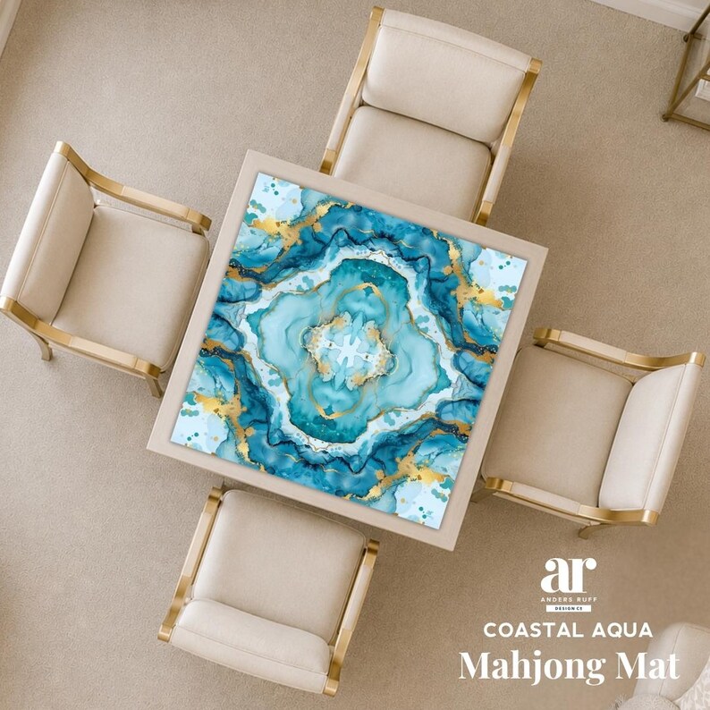 May include: A square mahjong mat featuring an abstract fluid art design in shades of aqua, teal, and white with gold metallic accents. The mat is centered on a square table surrounded by four beige chairs. Text reads: ar Anders Ruff Design Co. COASTAL AQUA Mahjong Mat.