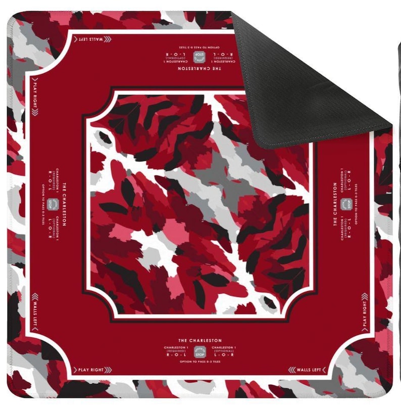 May include: A square game mat featuring a red, black, and white camouflage pattern in the center. The border is solid red with white text and directional arrows. The text reads The Charleston, Charleston 1, R-O-L, L-O-R, Play Right, and Walls Left.
